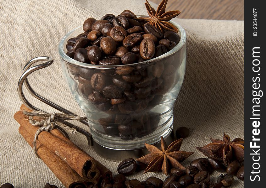 Grains in a cup of coffee, cinnamon and star anise. Grains in a cup of coffee, cinnamon and star anise