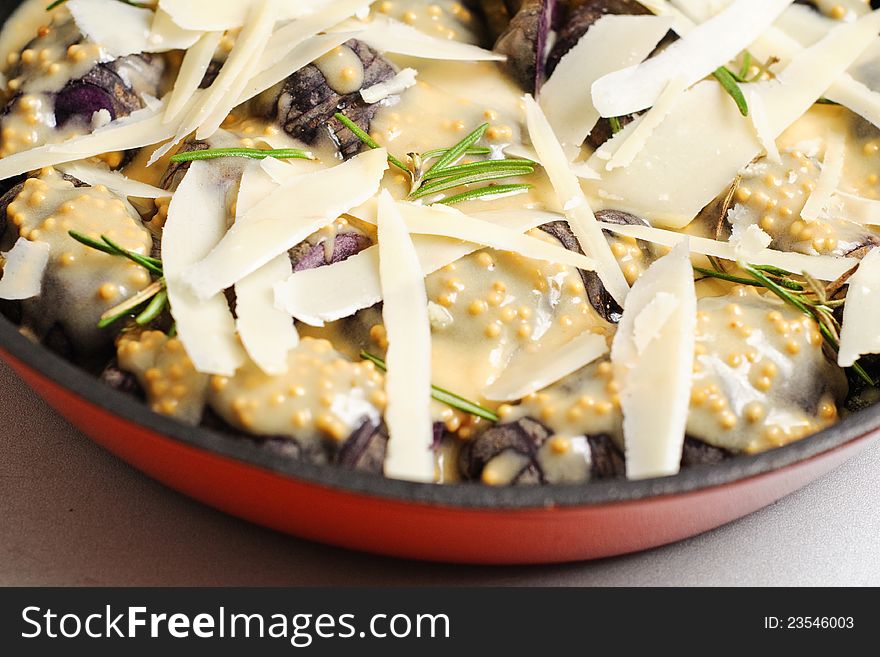 Violet potatoes with mustard sauce, rosemary and parmigiana