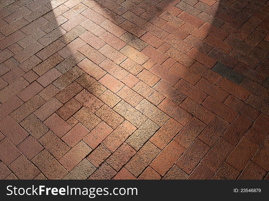 Spotlights shining on red brick pavement background walkway or patio floor