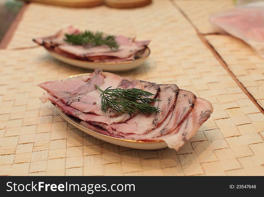 Sliced pork ham in dishes on table. Sliced pork ham in dishes on table.