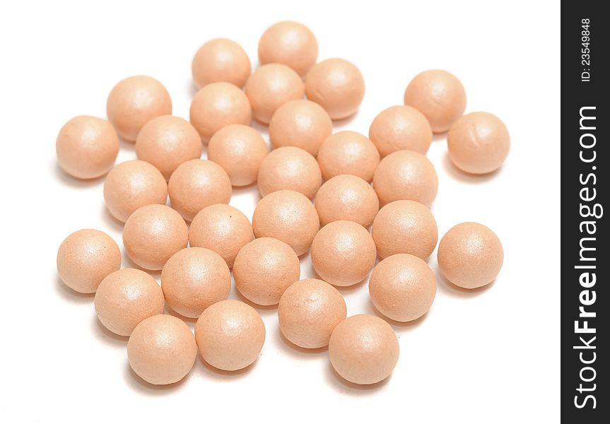 Face powder pearls (ball-powder) on a white background. Face powder pearls (ball-powder) on a white background
