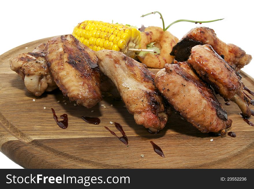 Chicken wings grilled with vegetables and corn. Chicken wings grilled with vegetables and corn