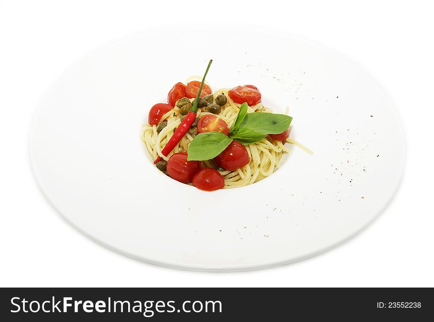 Pasta with tomato and pepper on a plate on a white background. Pasta with tomato and pepper on a plate on a white background