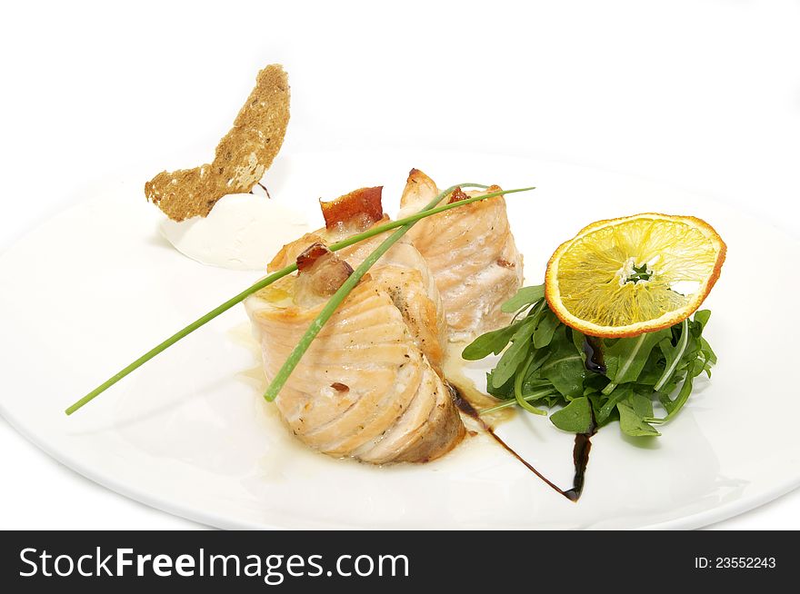 Fried fish with greens and rolls on a plate. Fried fish with greens and rolls on a plate