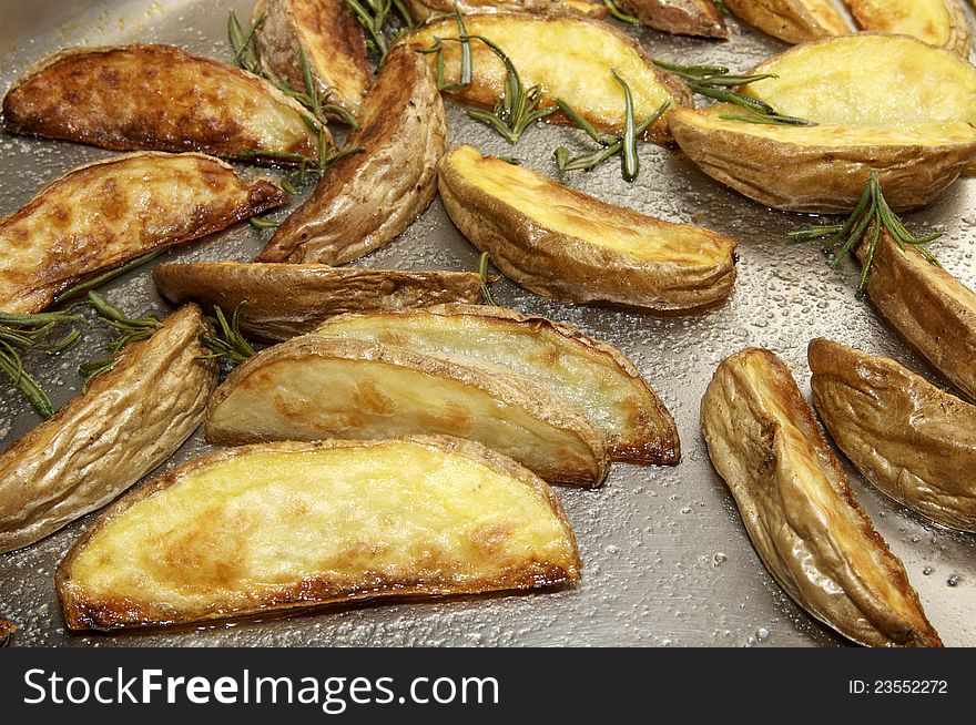 Pieces of golden fried potatoes in a pan close-up. Pieces of golden fried potatoes in a pan close-up