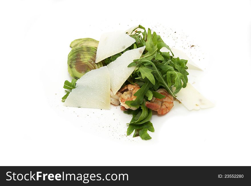 Shrimp with arugula on a plate on a white background