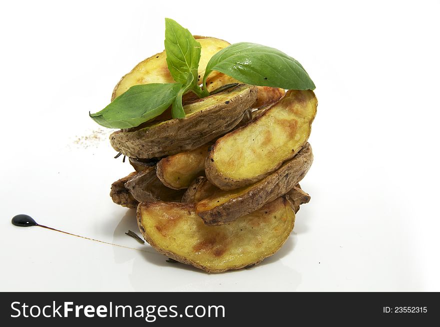 Baked potatoes on a plate decorated with greens