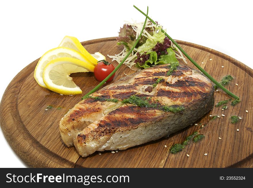 Grilled salmon on a plate with greens