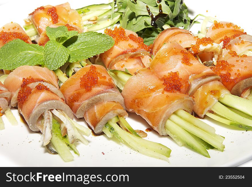 Fish rolls with herbs on a white background