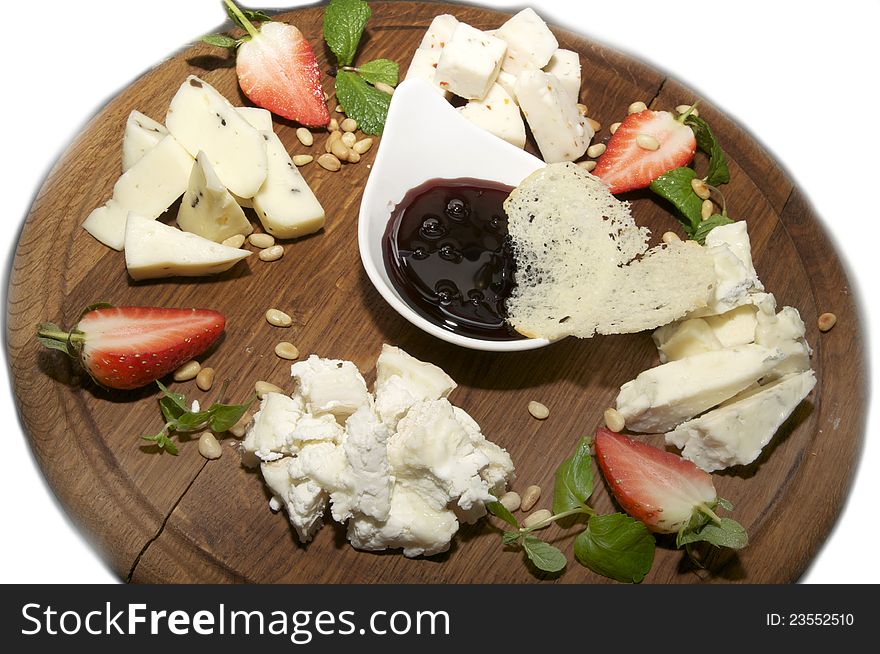 Cheese plate with several kinds of cheese sauce and strawberries