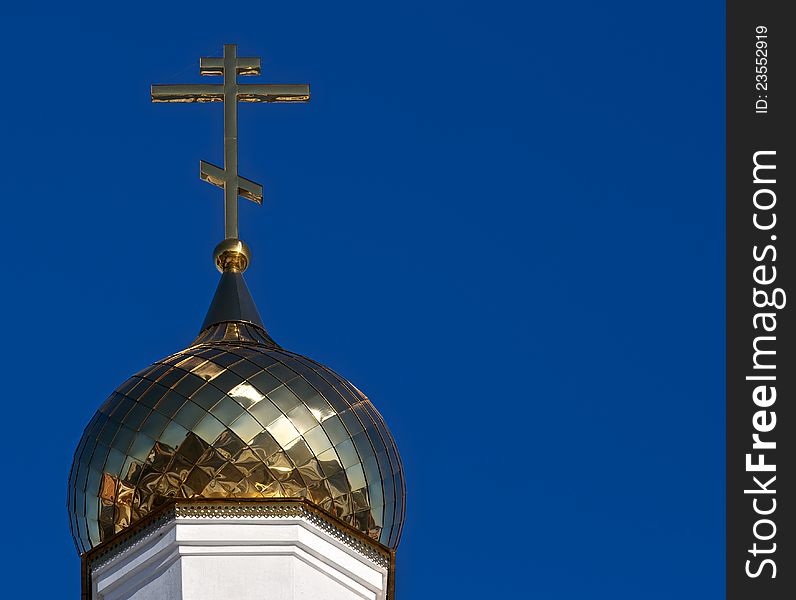 The golden dome gleams in the sun. He carries a gold cross, a symbol of the Christian Church. The golden dome gleams in the sun. He carries a gold cross, a symbol of the Christian Church.