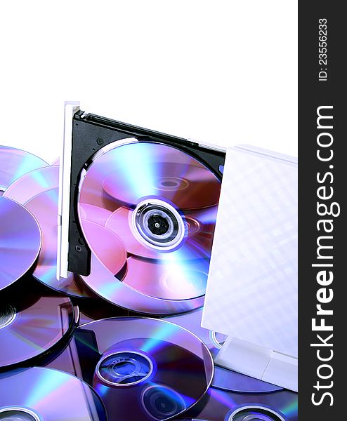 Poratble CD-RW/DVD-RW device with a disc inside & many discs with reflections on the  bottom cd's