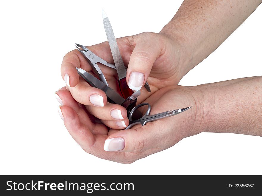 The hands holding a manicure set isolated on white. The hands holding a manicure set isolated on white
