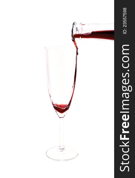 Red wine pouring in the glass from the bottle on white background. Red wine pouring in the glass from the bottle on white background