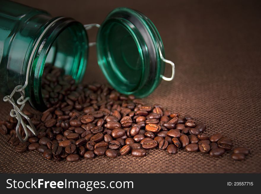 Coffee beans spilled from an vintage jar