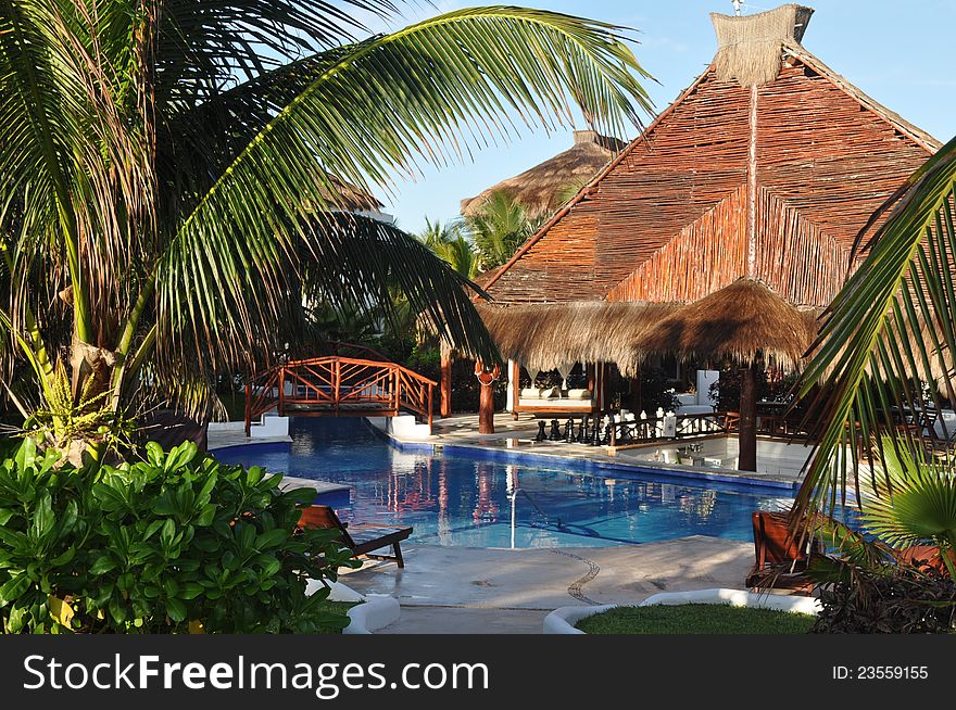 A tropical bar and pool area in a resort on the Riviera Maya. A tropical bar and pool area in a resort on the Riviera Maya