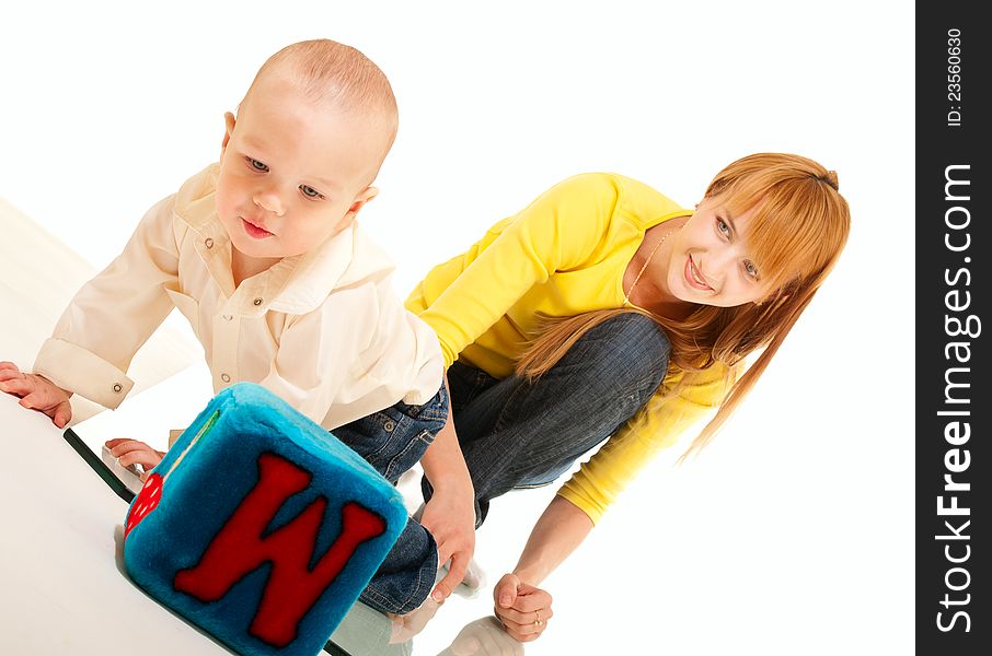 Son and mother play and study on white background