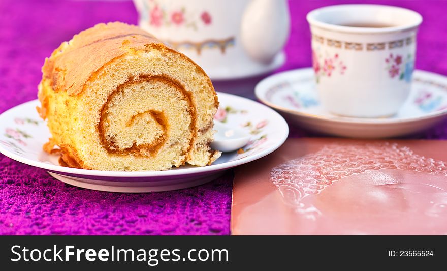 The sweets cake and tea are refreshments. The sweets cake and tea are refreshments