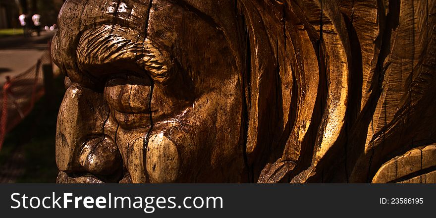 A wood carving of an Australian Aborginal man on a eucalyptus tree. A wood carving of an Australian Aborginal man on a eucalyptus tree.