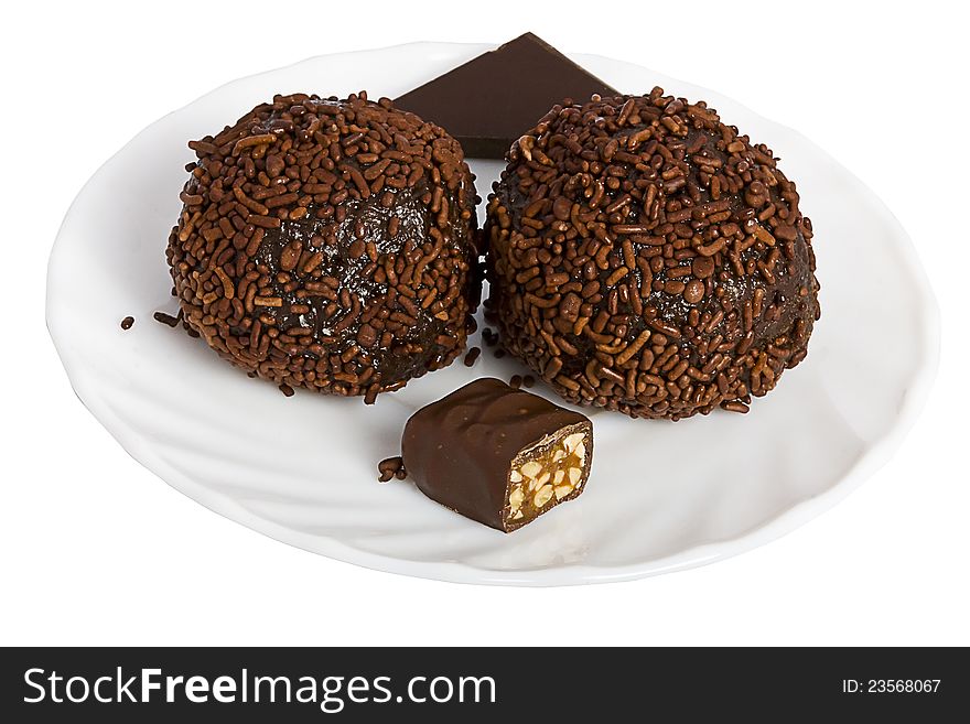 Various chocolate desserts on a white saucer isolated over white. Various chocolate desserts on a white saucer isolated over white.