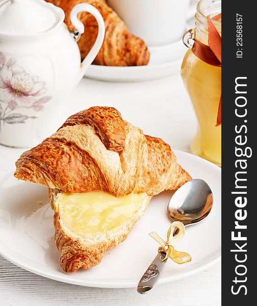 Breakfast with milk, lemon curd and croissants