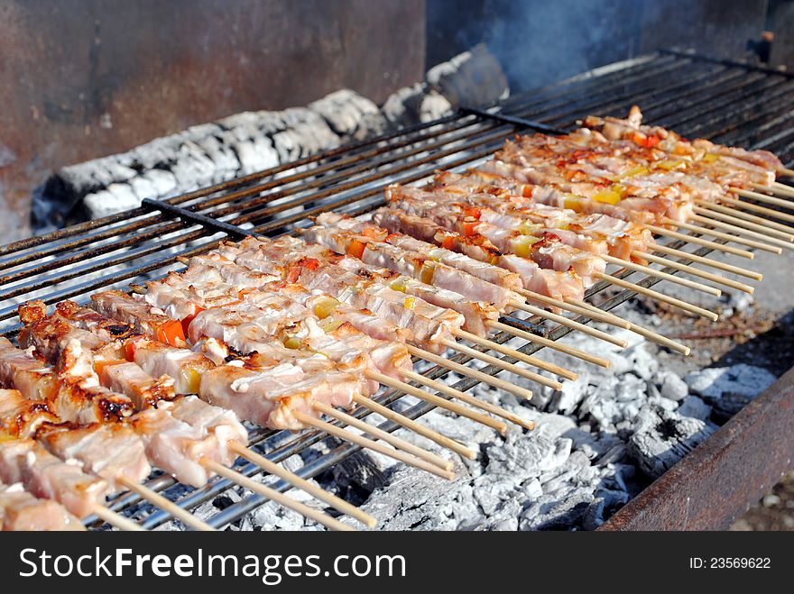 Cocked pork kabobs grilled on skewers on a barbecue