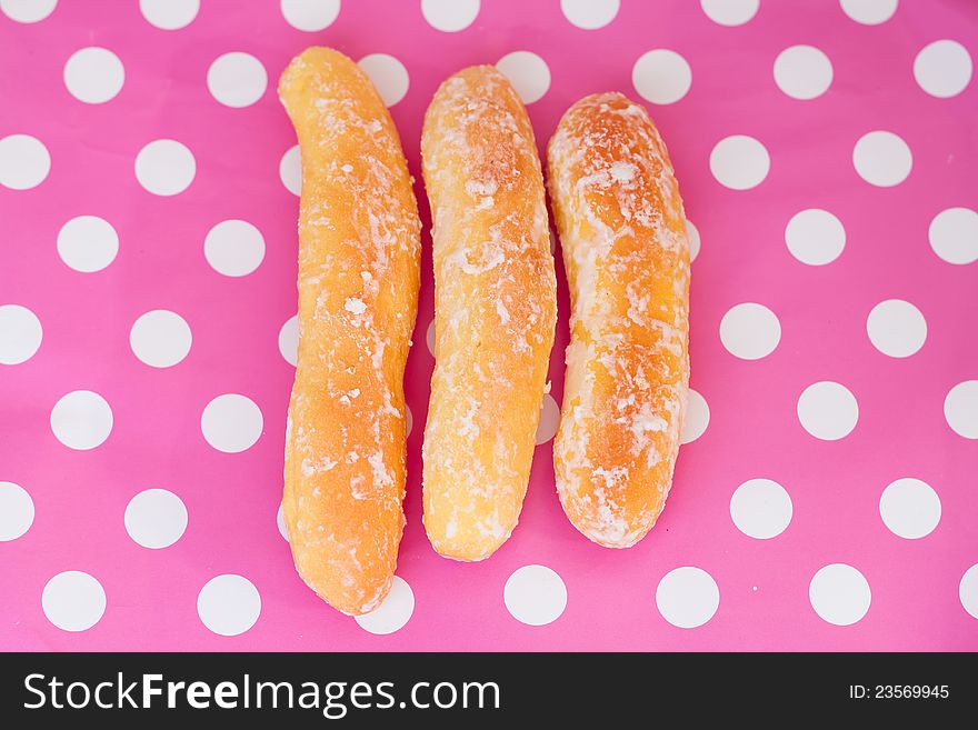 3 bread sticks on polka dot pink background. 3 bread sticks on polka dot pink background