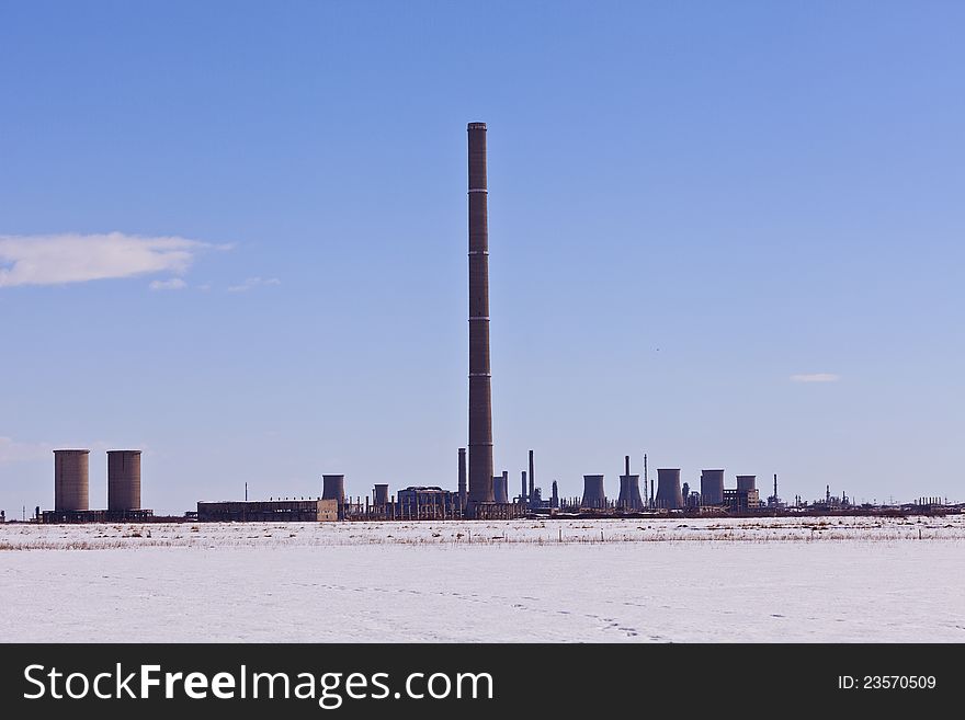 Industrial chimney in winter landscape