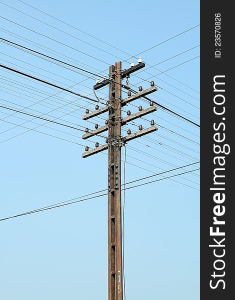 Old electric steel pole on blue sky background