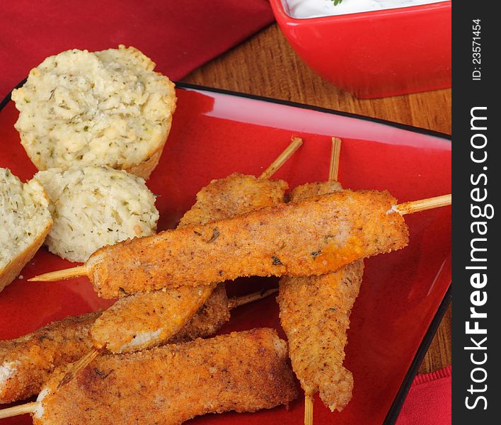 Chicken on skewers with biscuits on a plate. Chicken on skewers with biscuits on a plate