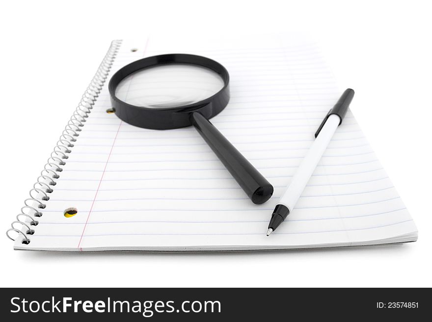 Open notepad with pen and lens  on white