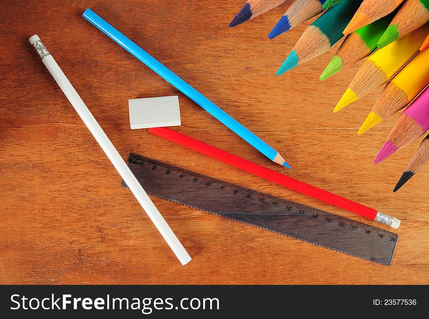 Color pencils and drawing objects on a wooden desk. Color pencils and drawing objects on a wooden desk.