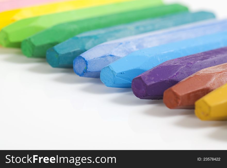 Group of crayons stacked on white background