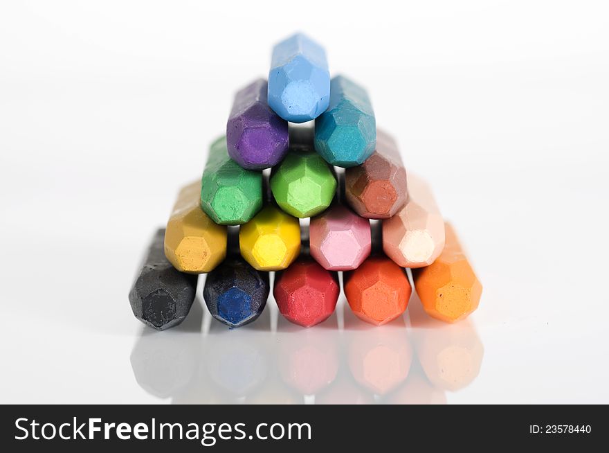 Group of crayons stacked on white background