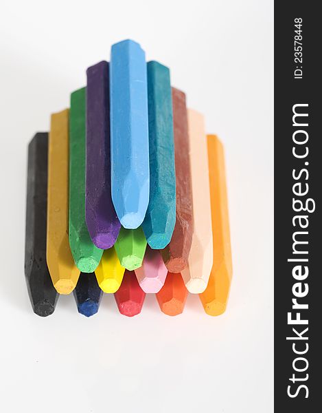 Group of crayons stacked on white background