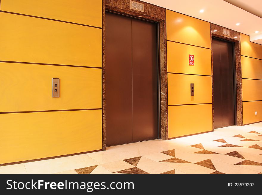 Hallway in a building interior with two elevators. Hallway in a building interior with two elevators.