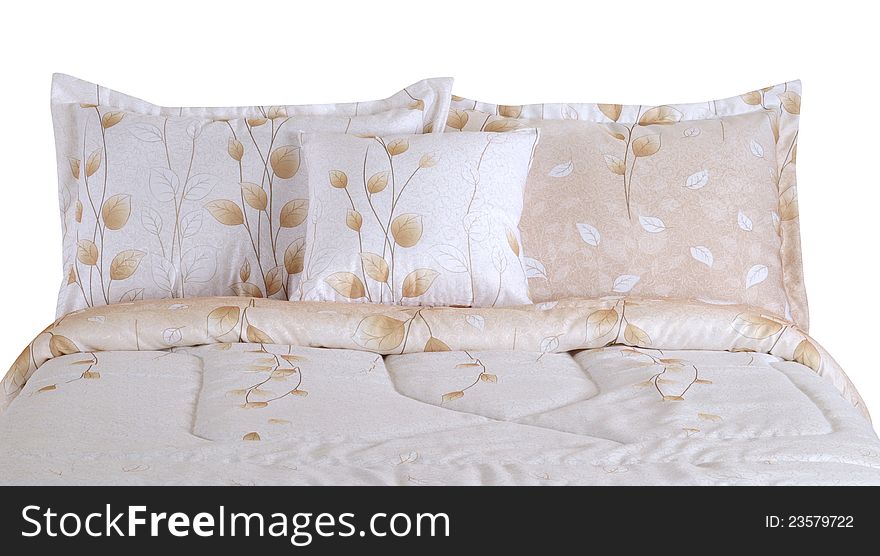 Soft pillows on bed spreads against white background. Soft pillows on bed spreads against white background.