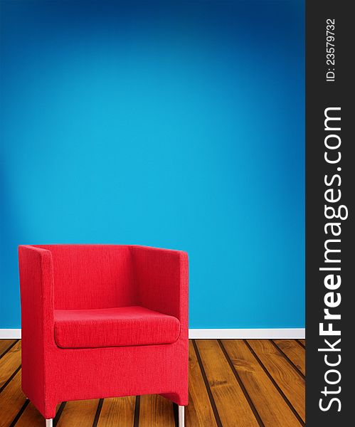 Red seat on wooden floor against blue background. Red seat on wooden floor against blue background.