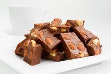 Broken Chocolate Pieces With Nuts On Plate Royalty Free Stock Image Broken Chocolate Pieces With Nuts On Plate Royalty Free Stock Image