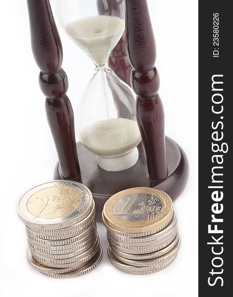 Time Is Money. Hourglass And Two Of Euro Coins