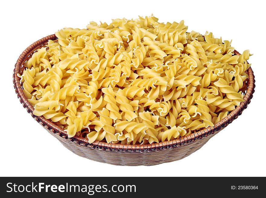 Raw pasta in a wicker basket isolated on white