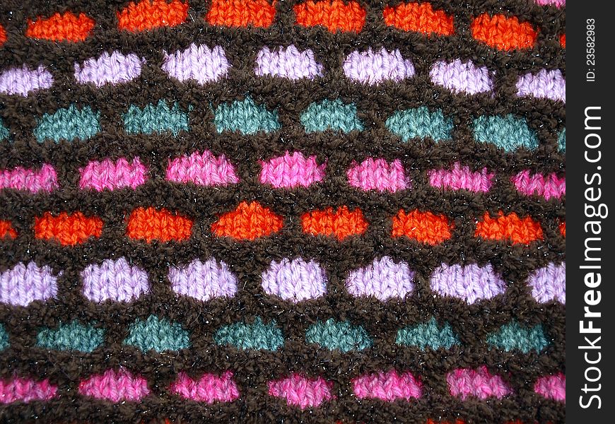 Multi-colored soft knitted fabric with a pattern. Textured background