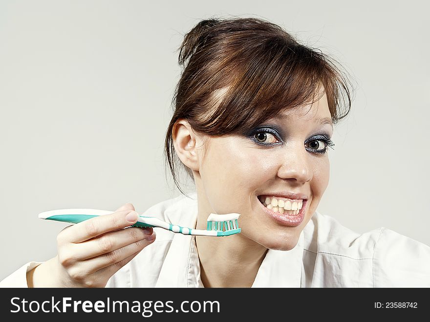 Girl keeps a toothbrush with toothpaste