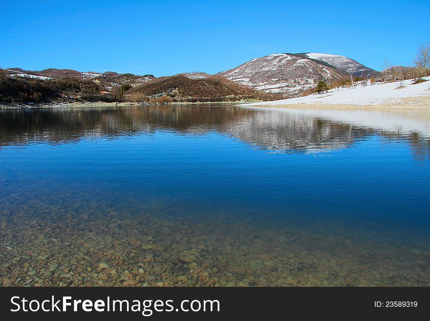 Mountain lake of Fiastra in the winter season - Marche (MC), Italy. Mountain lake of Fiastra in the winter season - Marche (MC), Italy.