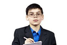 A Boy With Glasses Writes Royalty Free Stock Photos