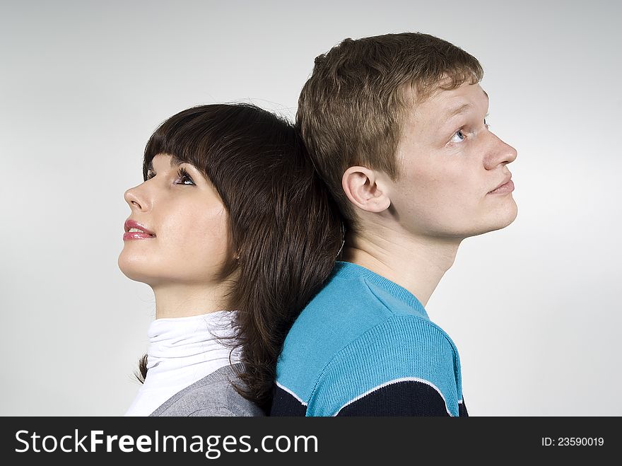 Guy standing back to back, a white background