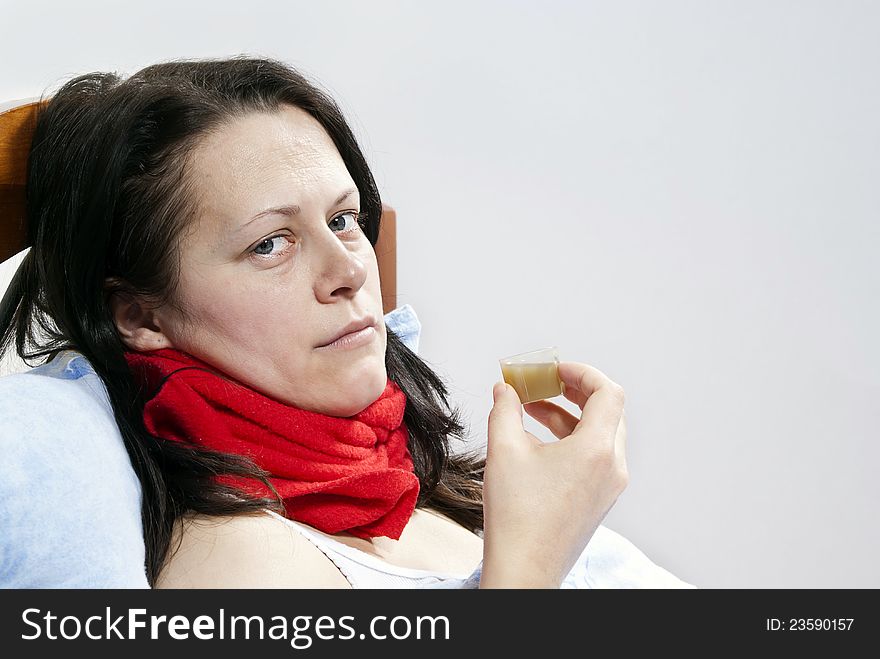 Sick girl drinks a medicine on the background of. Sick girl drinks a medicine on the background of