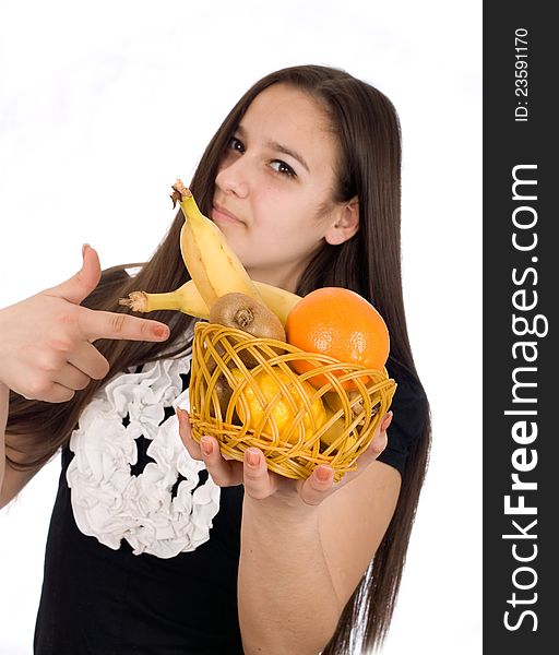 Beautiful girl holds out a basket of citrus fruit