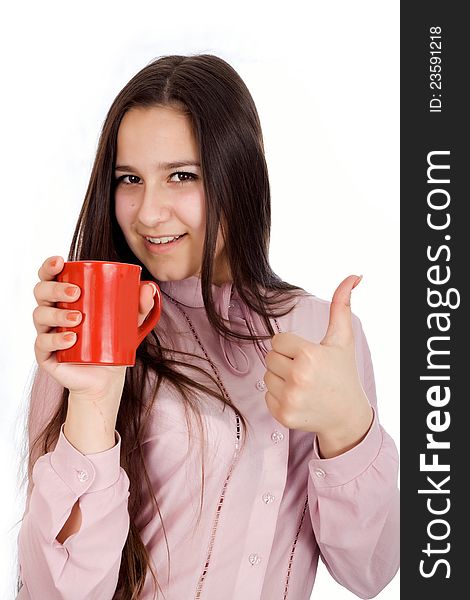 Woman holding a cup of delicious coffee showing Ok