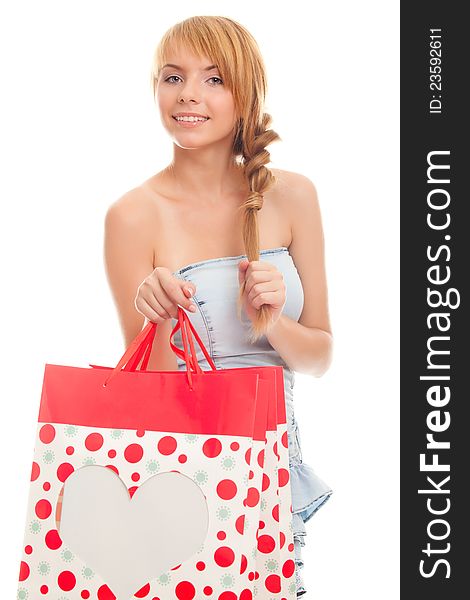 Beautiful young woman holding a red bag for shopping